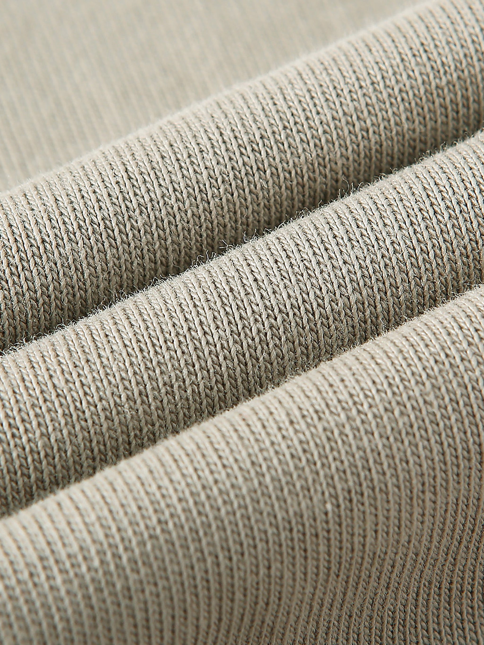 Close-up of beige fabric with a textured pattern