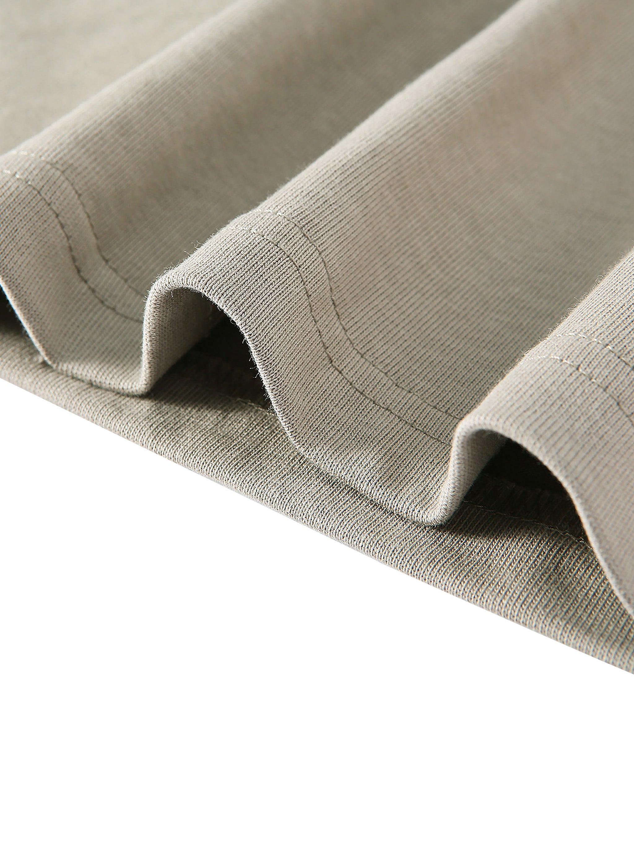 Close-up of beige fabric with a textured pattern on a white background