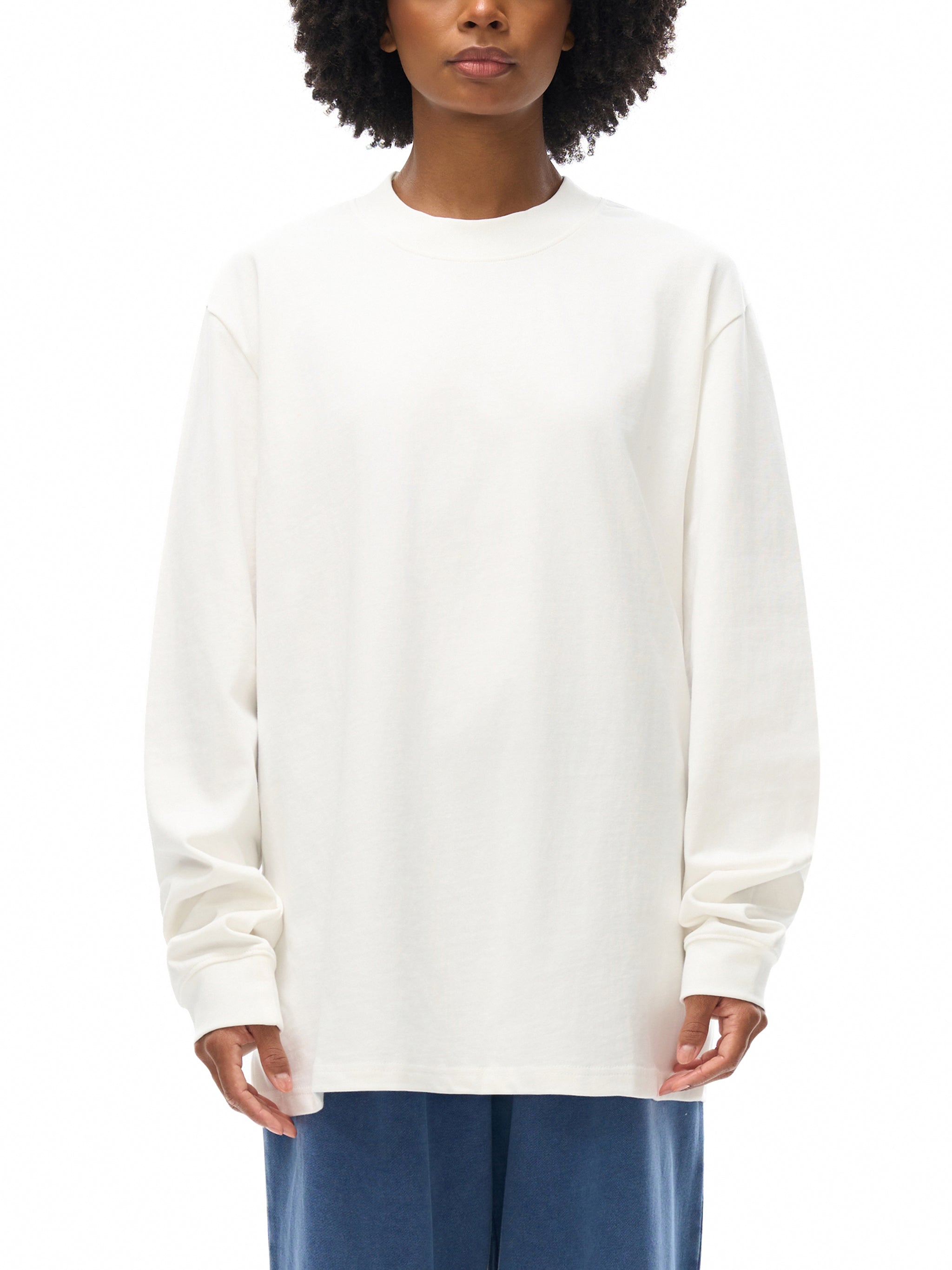 Person wearing a white sweatshirt on a white background